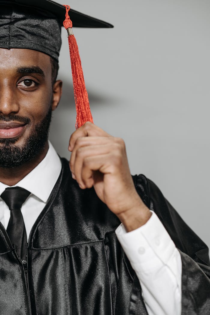 Photo of Man Holding Tassel